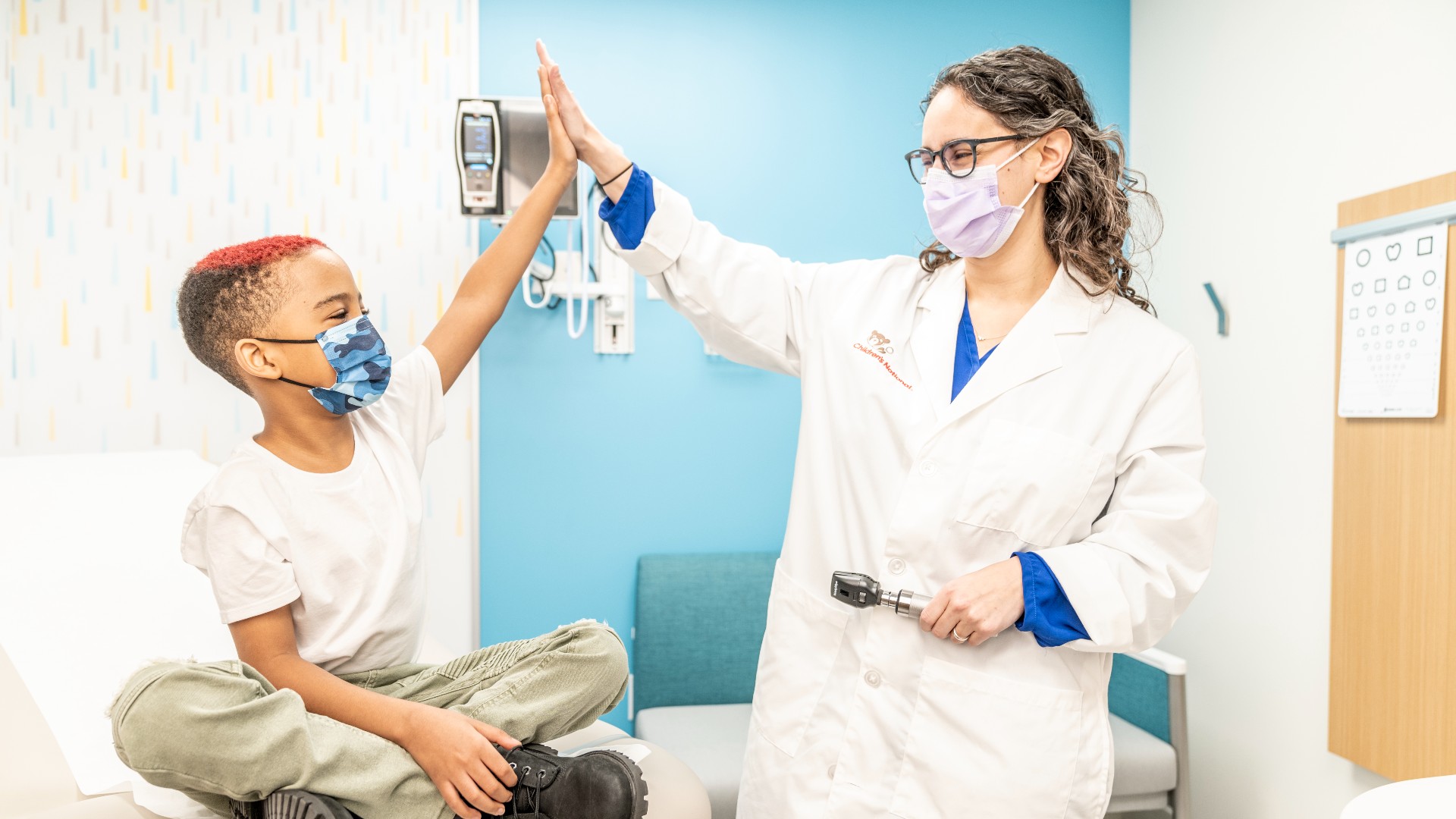 Provider and young boy giving a high five